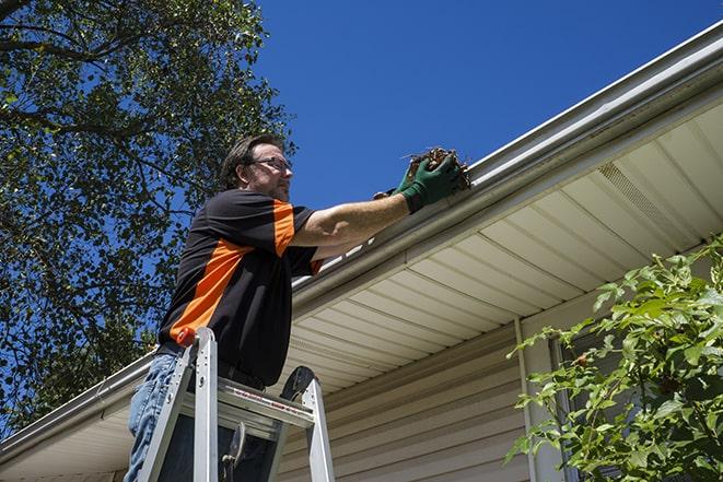 a professional repairing gutters damaged by a storm in Hobe Sound